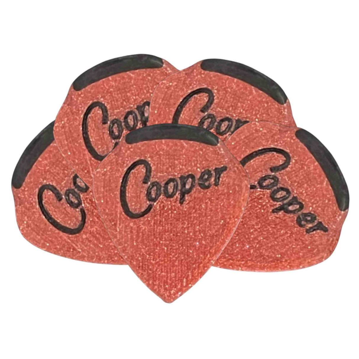 The image shows a set of teardrop-shaped Coor Cooper guitar picks with a reddish-orange sparkled finish and black decorative edges. The brand name "Coor Cooper" is printed in black on each pick. These visually striking picks are used by guitarists for plucking or strumming strings and serve as both practical playing tools and collectible items.