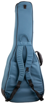 The image shows a steel blue/teal guitar gig bag with a padded, guitar-shaped design for acoustic or electric guitars. It features black trim, dual backpack-style straps, a top handle, a front accessory pocket, heavy-duty zippers, reinforced areas, and D-rings for durability. This lightweight, protective soft case is ideal for transporting guitars to gigs, lessons, or practice.