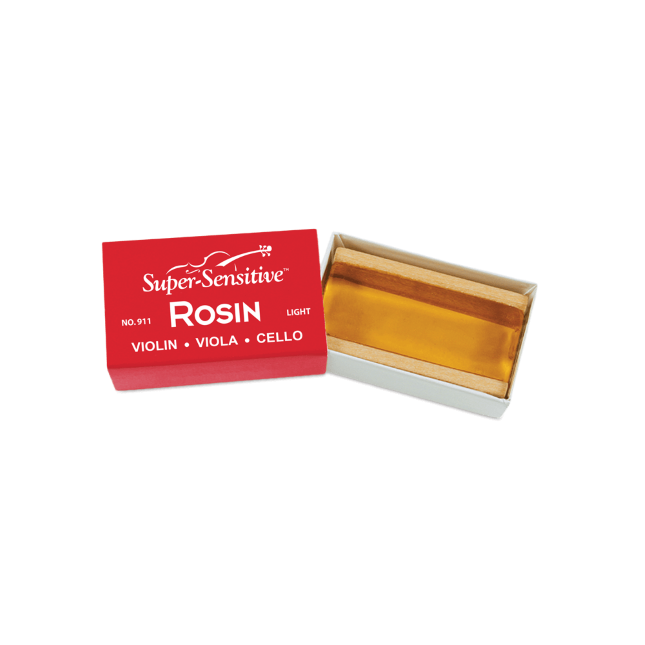 The image shows a block of "Super-Sensitive Rosin" in a light formulation, suitable for violin, viola, and cello. The translucent amber rosin is housed in red packaging labeled "Light" (No. 911). Rosin is made from tree resin and applied to bow hairs to create friction needed for sound production on string instruments. This softer rosin is preferred for warmer climates or players seeking a smoother bowing feel.