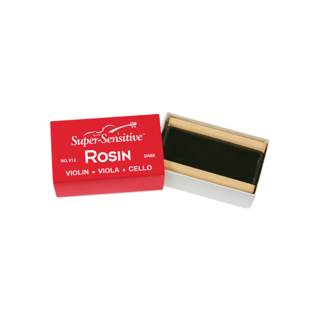 The image shows a block of "Super-Sensitive ROSIN" for violin, viola, and cello, labeled as the dark variety (No. 912). The rosin, dark amber or black in color, is housed in a small wooden or cardboard holder inside a red and white box. Rosin is essential for string instruments, applied to bow hair to create friction needed for sound when playing with a bow.