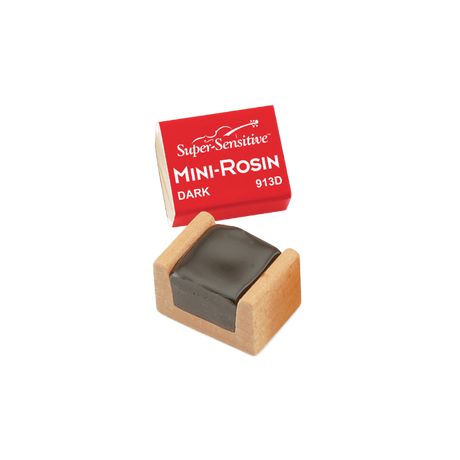 The image shows a Super-Sensitive Mini-Rosin model 913D in dark rosin, housed in a small wooden case. Dark rosin is favored for lower-pitched instruments like cellos and basses due to its softer, grippier texture. This compact size is ideal for musicians seeking a portable rosin cake to apply to bow hair, enhancing friction and sound production on string instruments like violins, violas, cellos, and basses.