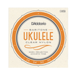 D'Addario Ukulele Baritone Clear Nylon guitar strings package, model EJ65B. The square cream-colored paper packaging features a prominent orange and dark gray circular graphic with the text 'D'Addario', 'UKULELE', and 'CLEAR NYLON'.