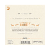 The back of a Baritone Ukulele string package by D'Addario, showing product information including string gauges 28, 34, 30w, 35w, model EJ65B, barcode, and branding on a cream-colored background.