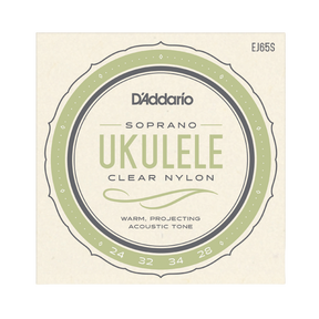 Packaging for D'Addario EJ65S ukulele strings with a beige background and green circle design with logos and string details.