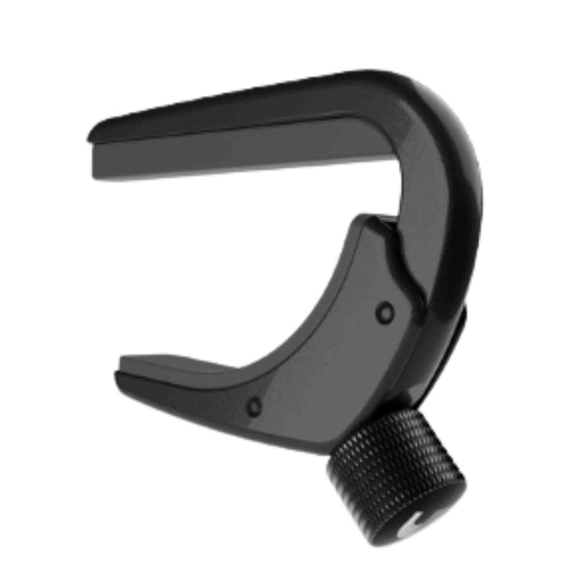 The image shows a black C-shaped guitar capo with padded contact surfaces to protect the strings and neck. It features a textured adjustment screw or trigger mechanism to secure it on the fretboard. Used to raise the pitch by clamping strings at a fret, it allows guitarists to play in different keys with familiar chords, commonly seen in folk, country, and acoustic music.