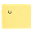 The image shows a yellow/golden D'Addario polishing cloth with a zigzag edge and the brand name and logo featuring curved parallel lines forming a "U" shape. This musical instrument care accessory is used to clean and maintain stringed instruments like guitars and basses by removing fingerprints, dust, and moisture to protect the finish.