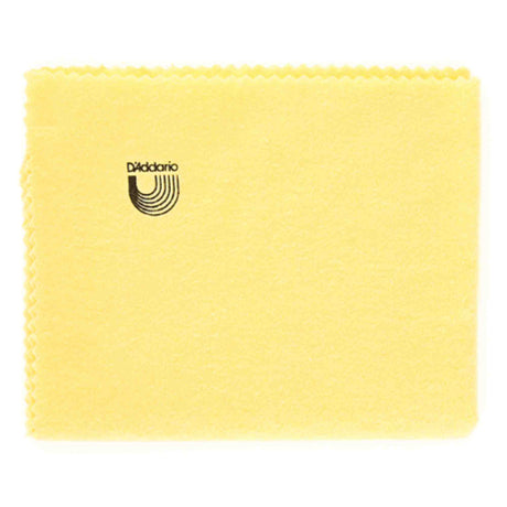 The image shows a yellow/golden D'Addario polishing cloth with a zigzag edge and the brand name and logo featuring curved parallel lines forming a "U" shape. This musical instrument care accessory is used to clean and maintain stringed instruments like guitars and basses by removing fingerprints, dust, and moisture to protect the finish.