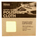 The image shows a D'Addario Planetwaves Napped Cotton Polishing Cloth package for guitar care. Made in the USA, the high-quality double napped cotton flannel cloth is untreated, ideal for buffing or applying polishes, waxes, and cleaners. The package includes a small window revealing the yellow/cream cloth and features an illustration of hands polishing an acoustic guitar. This accessory is essential for maintaining a guitar’s appearance and condition.