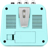 Turquoise guitar effects pedal with metallic clip on a white background