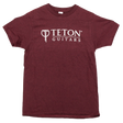 The image shows a maroon t-shirt featuring the Teton Guitars logo, displayed on a white background.