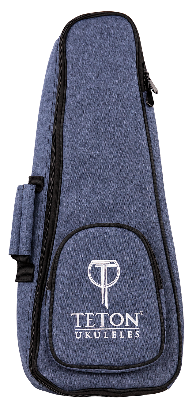 The image shows a Teton TBS25BL soprano ukulele gig bag in black. The bag features a zippered front pocket, padded shoulder straps, and a top handle for easy carrying. Its compact design is tailored to fit a soprano ukulele securely, providing protection during transport. The Teton logo is visible on the front pocket. The background is plain and the bag is displayed upright.