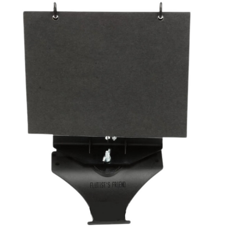 The image shows a professional-grade black music stand with a large, flat surface for sheet music, two metal clips at the top to hold pages, and a triangular base for stability. The base features the text "FLUTIST'S FRIEND," indicating it may be designed for flutists or wind players. This compact, portable stand is used by musicians to hold sheet music at a comfortable angle during practice or performance.