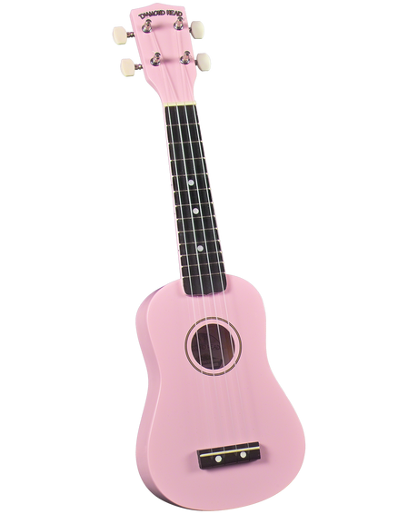 The image shows a bright pink soprano ukulele by Diamond Head with a traditional round sound hole and decorative rosette. It features four nylon strings, a dark wood fretboard with white fret markers, white tuning pegs, and a dark wood bridge. This beginner-friendly, small-sized ukulele is vibrant and appealing, especially for younger players or those who prefer colorful instruments.