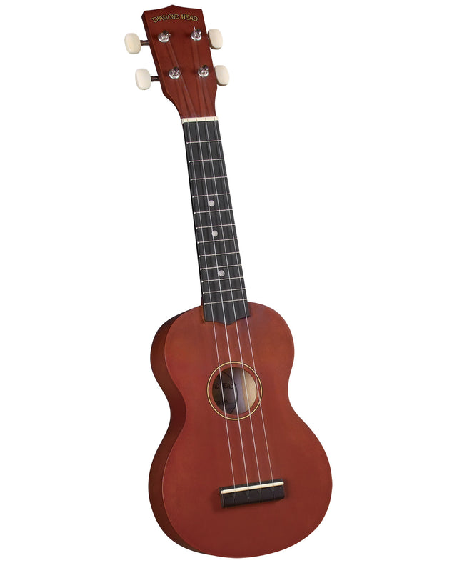 The image shows a soprano ukulele made by Diamond Head with a reddish-brown wooden figure-8 body, a dark fretboard with dot markers, four white tuning pegs, and the brand name on the headstock. It has four strings, a central sound hole, and a bridge at the bottom. This beginner-friendly ukulele produces a bright, cheerful sound typical of Hawaiian and folk music.
