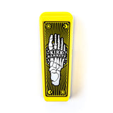 Top view of a yellow Kirk Hammett Dunlop wah pedal. There is a white and black skeleton foot design.