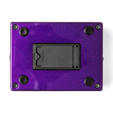 The bottom of a MXR bass pedal with a metallic purple finish and battery compartment.