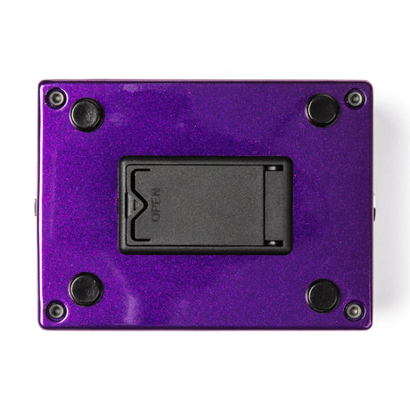 The bottom of a MXR bass pedal with a metallic purple finish and battery compartment.