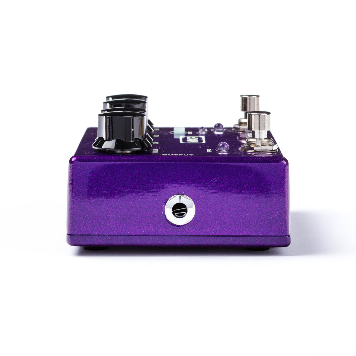 The left side of a MXR bass pedal with a metallic purple finish and various controls visible.