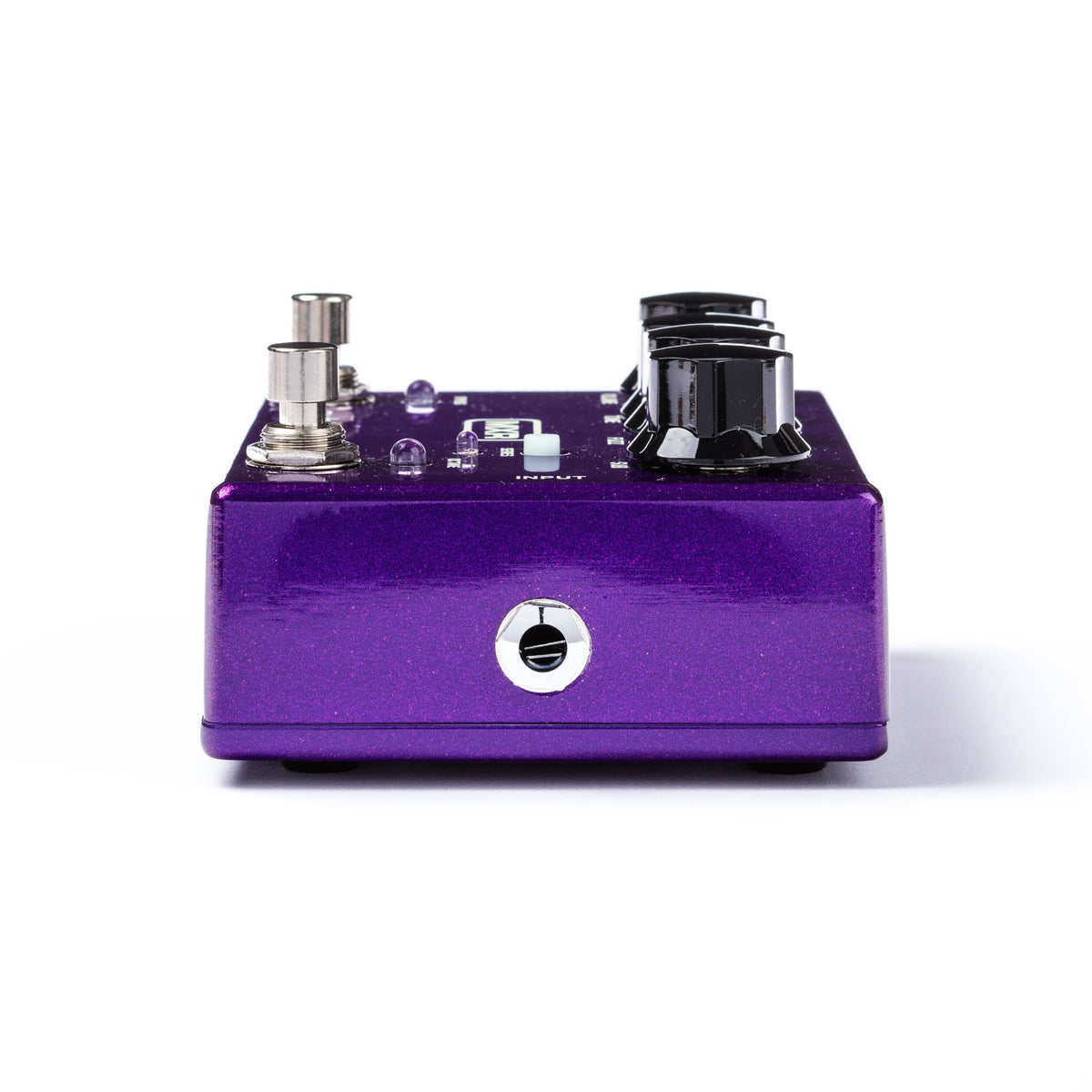 The right side of a MXR bass pedal with a metallic purple finish and various controls visible.