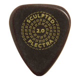 The image shows a dark-colored guitar pick with gold/yellow text reading "SCULPTED" at the top, "PLECTRA" at the bottom, and "2.0" in the center, surrounded by a dotted circular pattern. This branded pick likely belongs to the "Sculpted Plectra 2.0" line, suggesting ergonomic design or special texture for improved grip and playability. Guitar picks help musicians pluck or strum strings for varied tonal effects.