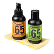 The image shows two Dunlop Formula 65 guitar care products: a 4 oz black spray bottle of Guitar Polish & Cleaner with an orange label, and a 4 oz black flip-top bottle of Cream of Carnauba with a green label. A yellow textured polishing cloth is also included. These products are used to clean, polish, and protect guitar finishes, helping maintain the instrument’s appearance and condition.