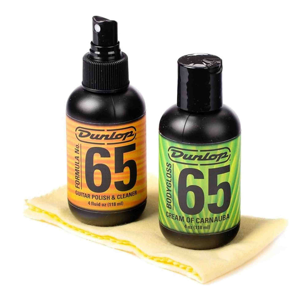The image shows two Dunlop Formula 65 guitar care products: a 4 oz black spray bottle of Guitar Polish & Cleaner with an orange label, and a 4 oz black flip-top bottle of Cream of Carnauba with a green label. A yellow textured polishing cloth is also included. These products are used to clean, polish, and protect guitar finishes, helping maintain the instrument’s appearance and condition.