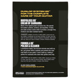The image shows the back of a Dunlop System 65™ guitar care kit package, featuring two main products: Bodygloss 65™ Cream of Carnauba, a wax that polishes and protects guitar finishes, and Formula 65™ Polish & Cleaner, which removes buildup while polishing. The kit also includes two microfiber cloths and safety warnings, providing comprehensive maintenance for guitar protection and shine.