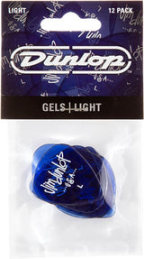 The image shows a 12-pack of Dunlop Gels Light guitar picks in translucent blue. The picks, visible through clear plastic packaging, feature the Dunlop USA logo. The packaging has Dunlop branding on a blue background with musical notes. These thin, flexible picks are made from Dunlop's Gels material, ideal for strumming and lighter playing styles. Dunlop is a well-known guitar accessory manufacturer.