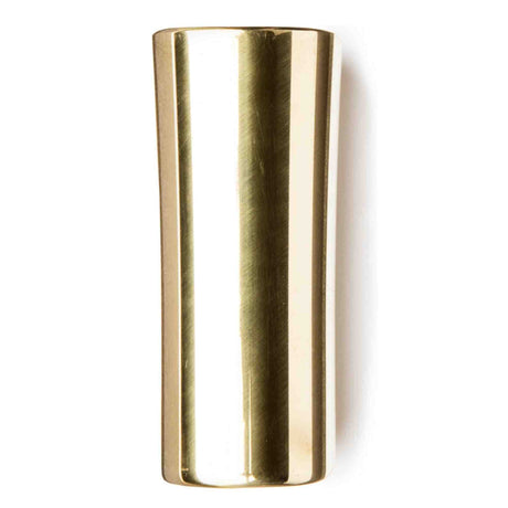 The image shows a brass guitar slide, a polished cylindrical tube used to create smooth, gliding tones by sliding along guitar strings. Commonly worn on the ring finger or pinky, slides come in various materials like glass, ceramic, steel, and brass, each affecting tone. Brass slides produce a warm, mellow sound with good sustain and are essential for blues, country, rock, and other slide guitar styles.