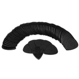 The image shows a collection of black guitar picks arranged in a curved, fan-like pattern. These standard teardrop-shaped plectrums are made of dark plastic, possibly celluloid, with faint embossed logos or text. Likely a bulk pack, they are essential accessories for guitar players used to strum or pluck strings and come in various materials and thicknesses to suit different playing styles.