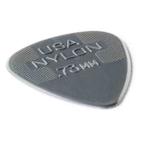 The image shows a Dunlop Nylon guitar pick in dark gray/black with a thickness of 0.73mm. It features the classic teardrop shape and textured crosshatched grip areas on the upper part to prevent slipping. This medium gauge pick is popular for its durability and balanced flexibility, suitable for both strumming and detailed picking.