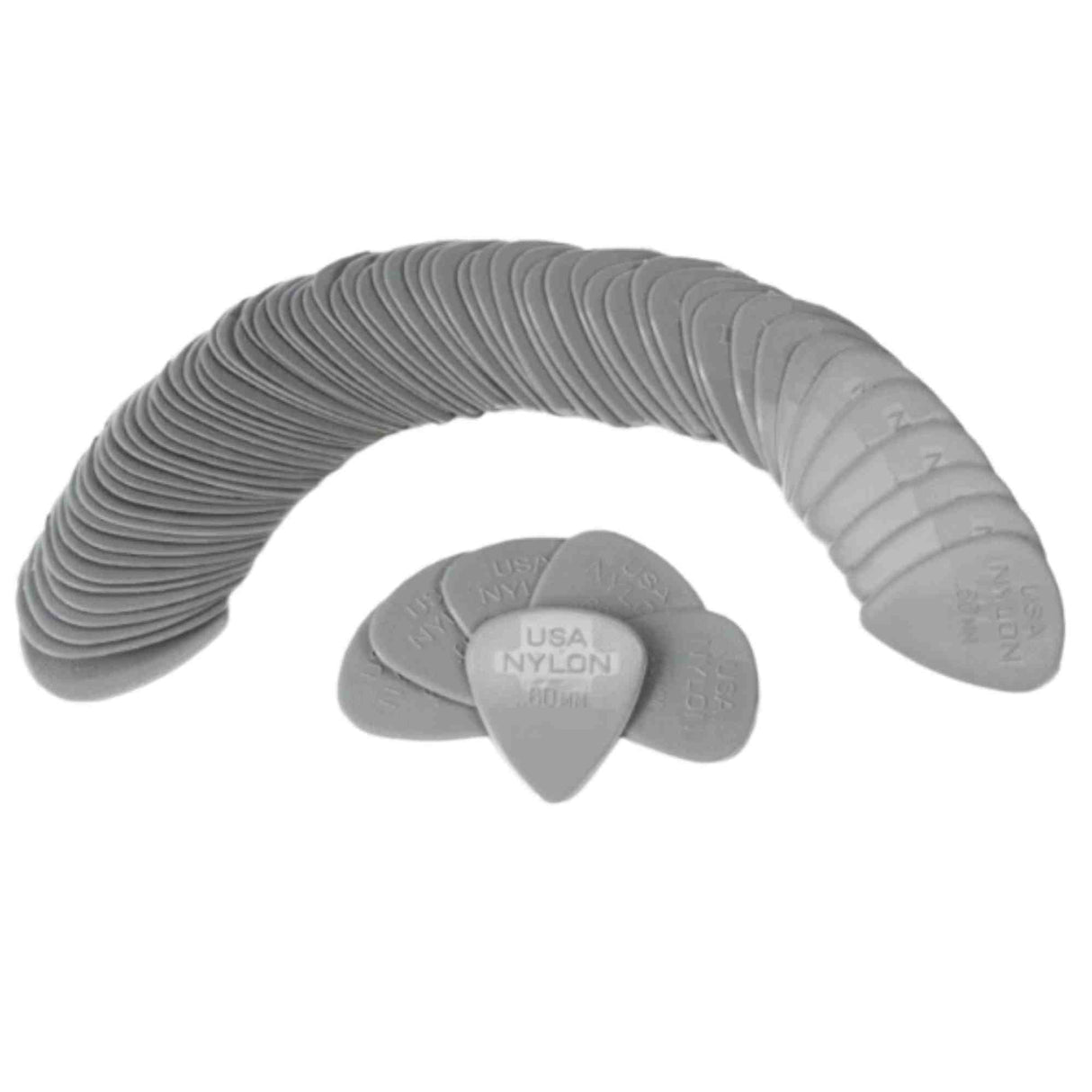 The image shows a large collection of gray nylon guitar picks arranged in a curved, fan-like display. Several picks in the foreground show text reading "USA NYLON" with thickness markings like ".60." These classic guitar accessories are essential for playing, valued for their flexibility and durability. The quantity suggests a bulk pack or display, common for guitarists who frequently replace picks.