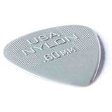 The image shows a grayish-green, semi-translucent nylon guitar pick marked "USA NYLON" with a thickness of 0.60 mm. It has a classic teardrop shape and a textured edge for better grip. This light to medium gauge pick offers a smooth feel and warm tone, making it versatile for both strumming and picking.