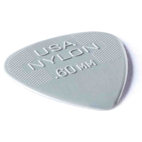 The image shows a grayish-green, semi-translucent nylon guitar pick marked "USA NYLON" with a thickness of 0.60 mm. It has a classic teardrop shape and a textured edge for better grip. This light to medium gauge pick offers a smooth feel and warm tone, making it versatile for both strumming and picking.