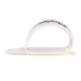 The image shows a clear or translucent white guitar fingerpick made of plastic or celluloid. It has a curved, teardrop shape with a band that wraps around the finger, typically the thumb, and an extended picking surface. Some text or branding is visible but not legible. Fingerpicks like this are used in fingerstyle, bluegrass, country, and folk music to produce a brighter tone and protect fingertips during playing.
