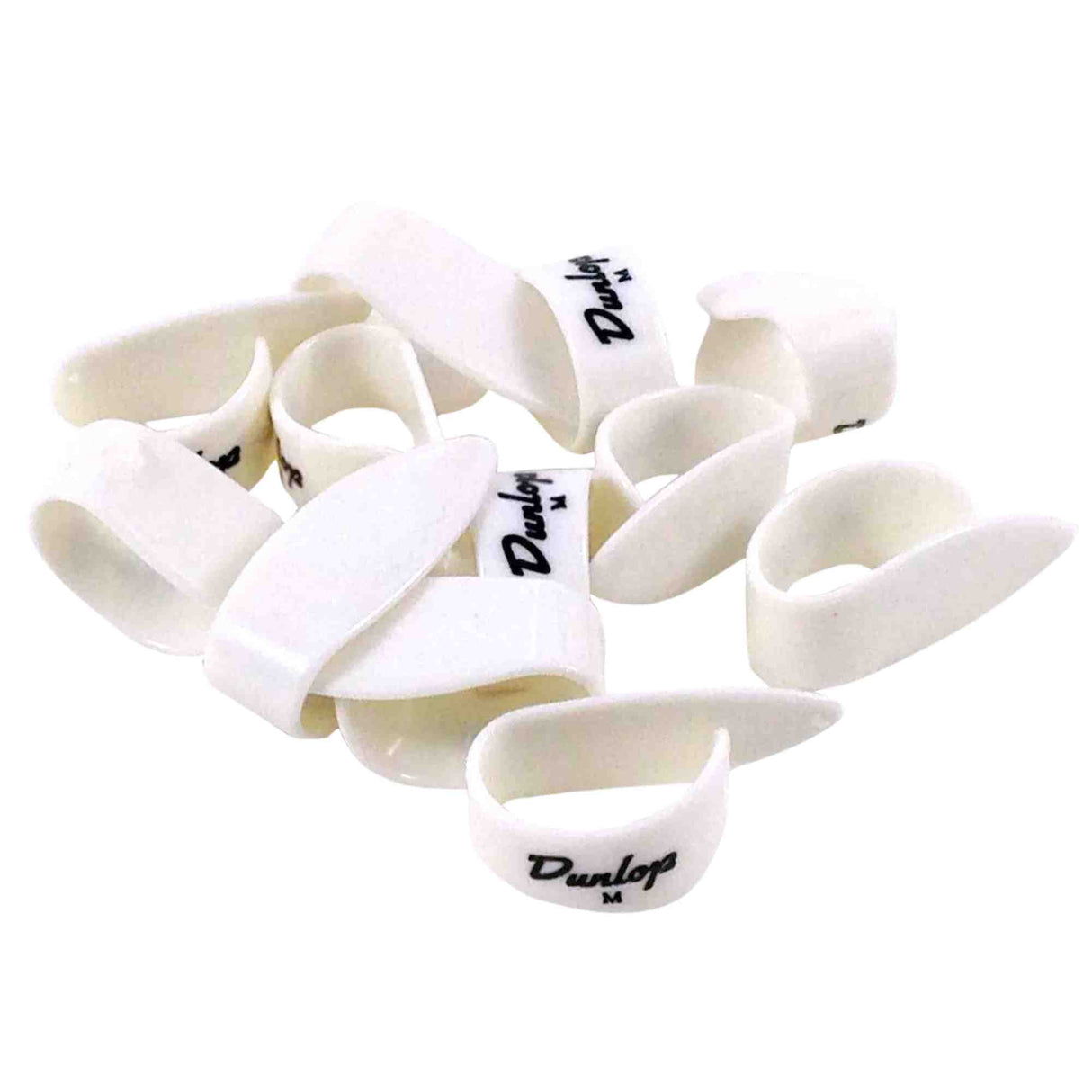 The image shows a pile of white Dunlop guitar picks featuring the Dunlop logo and "M" size markings, indicating medium thickness. Made of plastic or celluloid, these teardrop-shaped picks are common accessories used by guitarists to strum or pluck strings.