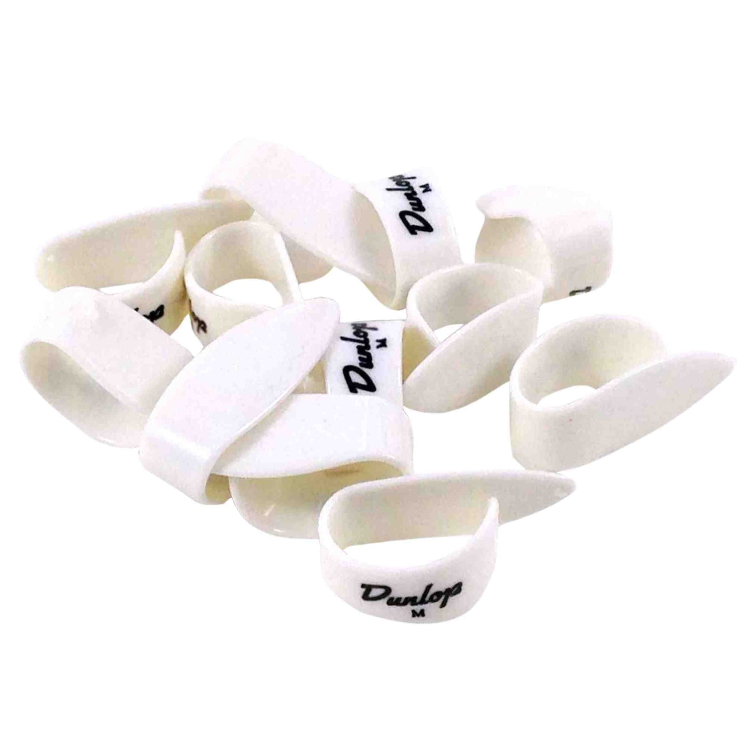 The image shows a pile of white Dunlop guitar picks featuring the Dunlop logo and "M" size markings, indicating medium thickness. Made of plastic or celluloid, these teardrop-shaped picks are common accessories used by guitarists to strum or pluck strings.