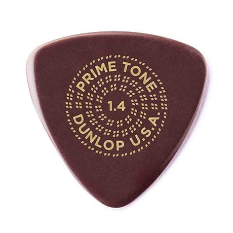 The image shows a Dunlop "Prime Tone" guitar pick with a 1.4mm thickness. It has a dark reddish-brown color and gold lettering arranged in a circular pattern: "PRIME TONE" at the top, "1.4" in the center, and "DUNLOP U.S.A." at the bottom, surrounded by decorative dots. This premium pick offers a thicker, firm feel favored by lead guitarists and players seeking greater control.