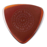 The image shows a Dunlop Primetone guitar pick with a 1.4mm thickness. It has a translucent amber teardrop shape with darker edges fading to a lighter center. The pick features a textured dotted grip and embossed text reading "PRIMETONE," "1.4," and "DUNLOP USA." Known for quality, this thick pick offers precision and control, ideal for lead guitar, jazz, and players seeking a fuller tone.