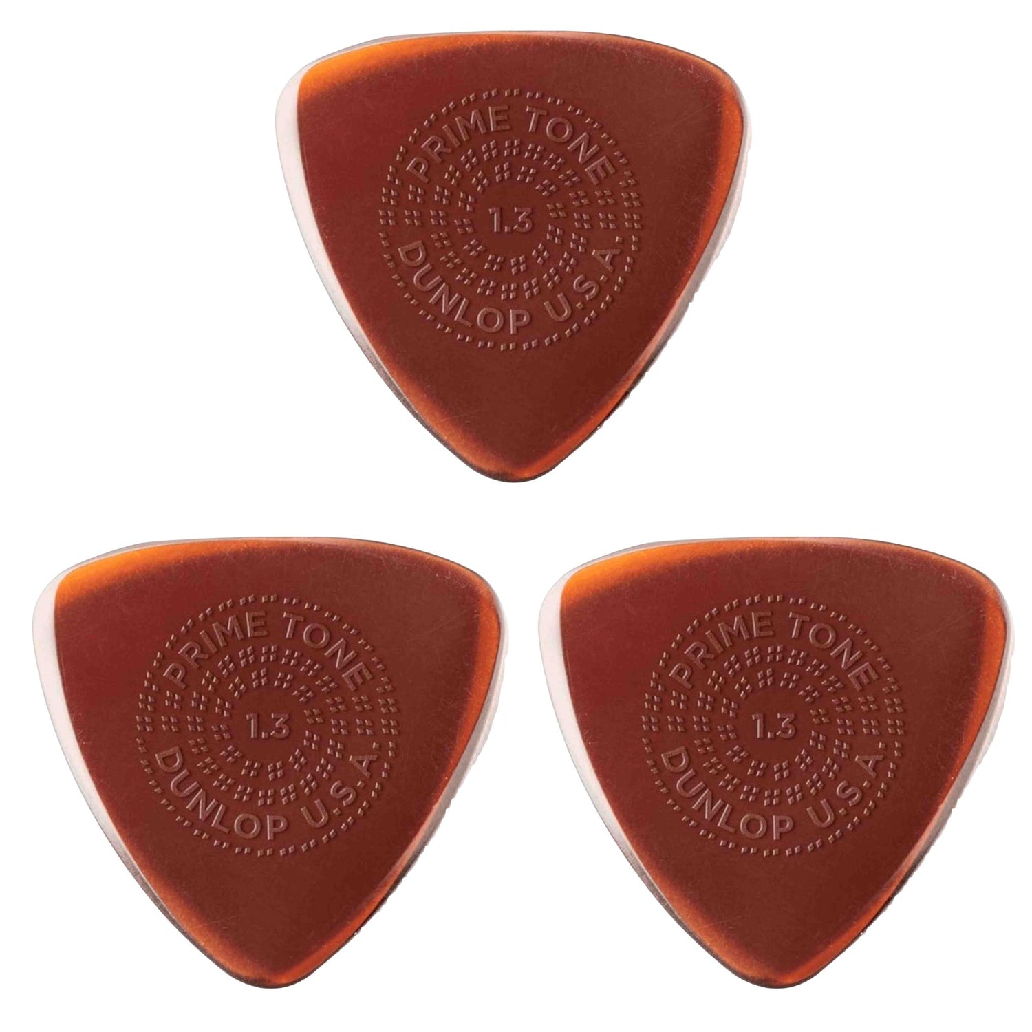 The image shows three Dunlop "Prime Tone" guitar picks, each 1.5mm thick with a triangular shape and amber/tortoiseshell color. They feature embossed circular text: "PRIME TONE" at the top, "1.5" in the center, and "DUNLOP USA" at the bottom, surrounded by decorative dots. These premium picks offer a firm feel and bright tone, favored by many guitarists for their classic look and quality.