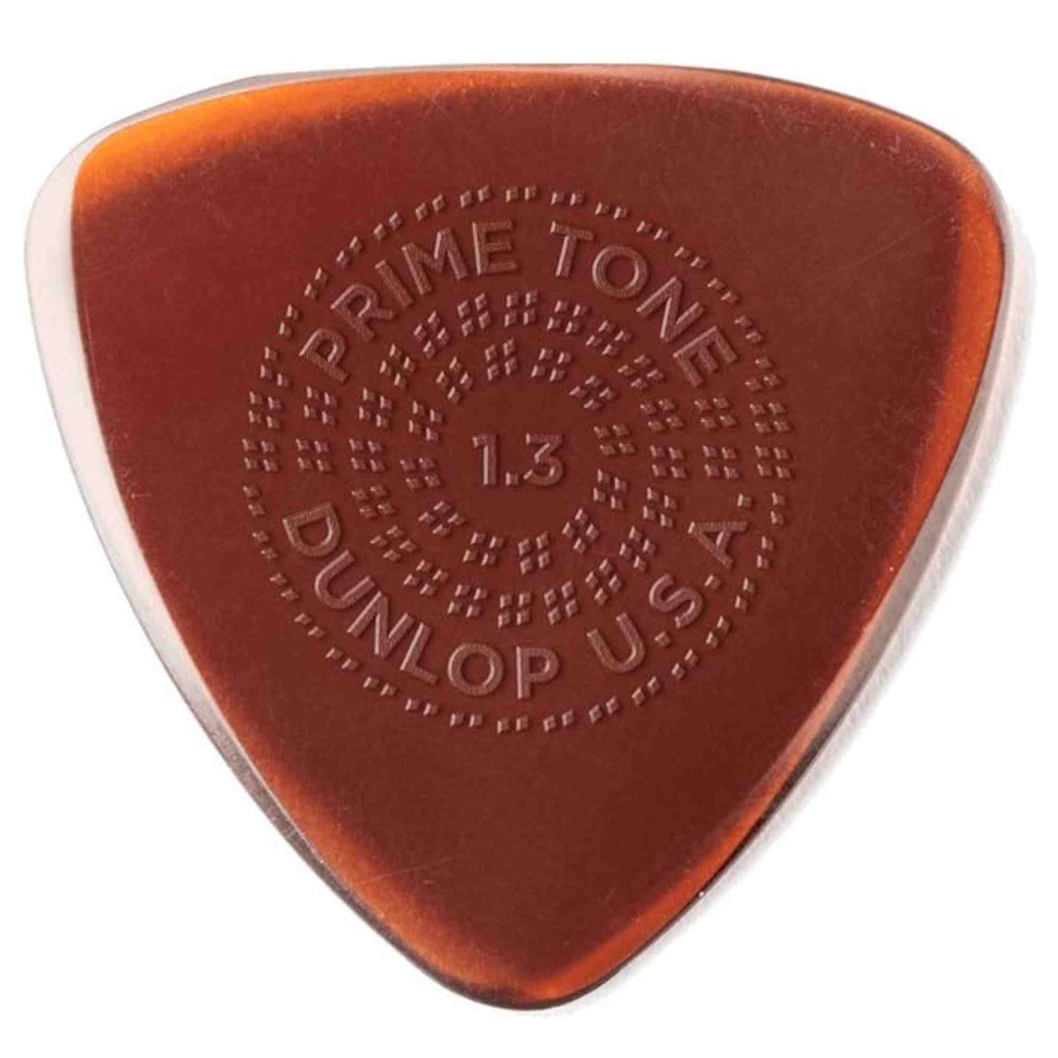 The image shows a Dunlop Prime Tone guitar pick in translucent amber/orange with embossed text: "PRIME TONE" at the top, "DUNLOP" at the bottom, and "1.3" in the center indicating its 1.3mm thickness, along with "U.S.A." The textured surface has small raised dots in a circular pattern for enhanced grip. This thick pick is designed for control and a fuller tone, popular in rhythm playing.
