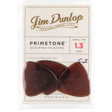 The image shows a package of three Jim Dunlop Primetone Sculpted guitar picks. These small triangular picks are 1.3mm thick, made in the USA from brown/amber material, and feature Dunlop branding. Known for their hand-burnished finish, they offer enhanced grip and tone, ideal for players seeking a sturdy, precise pick.