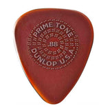 The image shows a Dunlop Primetone guitar pick in translucent amber/tortoiseshell color. It has embossed circular text: "PRIMETONE" at the top, "DUNLOP" at the bottom, "USA" on the right, and "88" in the center, likely indicating thickness. Known for premium materials, a sculpted tip, and embossed grip, it offers precision, tone, and durability favored by professional guitarists.