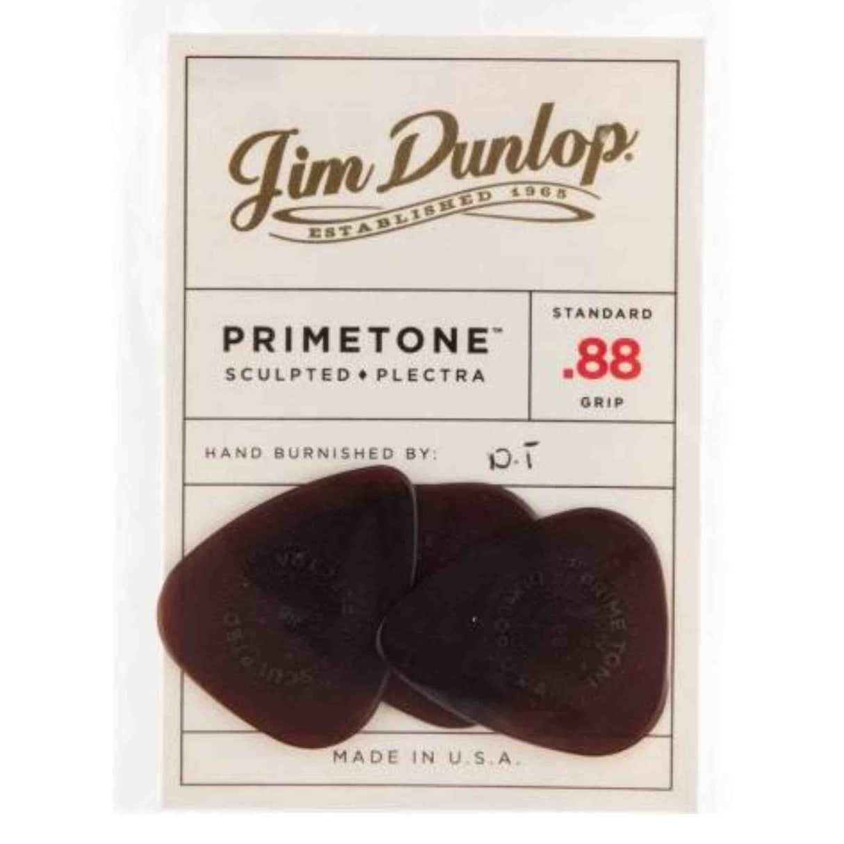 The image shows a package of three Jim Dunlop Primetone guitar picks. They are standard .88mm thick, made of sculpted Plectra material with a textured grip and hand-burnished edges. The picks have a dark reddish-brown tortoiseshell color and are made in the USA. Known for premium quality, these picks offer improved tone, control, and reduced pick noise, favored by guitarists for smooth playability.