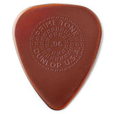 The image shows a Dunlop Primetone guitar pick in reddish-brown/amber with embossed text arranged circularly. It reads "PRIMETONE" at the top, ".96" in the center, "DUNLOP" at the bottom, and "U.S.A." on the right, surrounded by dotted decorative elements. This .96mm medium-heavy pick is from Dunlop’s premium Primetone series, known for quality materials and craftsmanship.