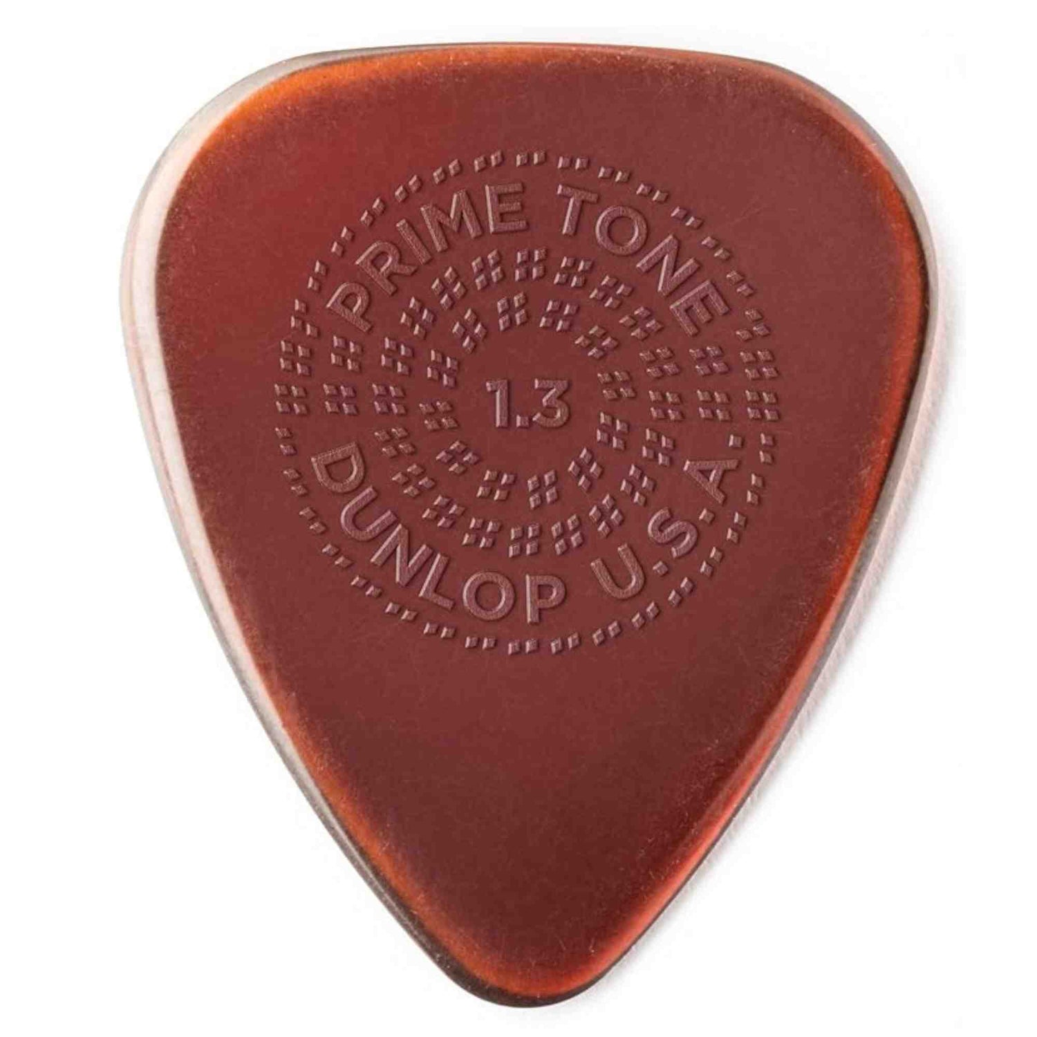 The image shows a Dunlop Primetone guitar pick, 1.3mm thick, in amber/tortoiseshell color. It features embossed circular text: "PRIME TONE" at the top, "1.3" in the center, "DUNLOP" at the bottom, and "U.S.A." on the side. Known for its smooth surface, durable build, and textured grip, this medium-heavy pick offers control and comfort, popular among guitarists across various genres.