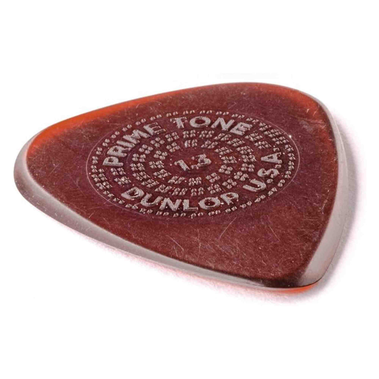 The image shows a teardrop-shaped guitar pick from Primetone USA, featuring a translucent reddish-brown amber color. It has embossed circular text around the edge reading "PRIMETONE USA" with additional text. Made from high-quality material, the pick is designed for durability, tone quality, and grip, making it a favored accessory for guitarists.