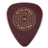 The image shows a dark reddish-brown "Sculpted Plectra" guitar pick with 1.0mm thickness. It features gold/yellow text with "SCULPTED" curved at the top, "1.0" in the center, and "PLECTRA" curved at the bottom, all surrounded by concentric dotted circles. The pick's design and branding suggest it is a premium, specialty material guitar pick.