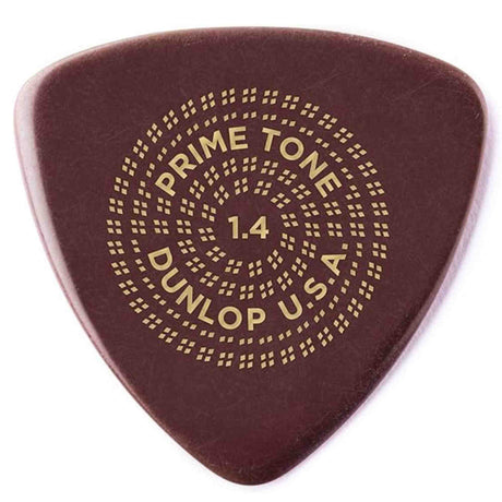 The image shows a Dunlop Primetone guitar pick in dark reddish-brown with gold text and decorative dotted circles. It is 1.4mm thick, with "PRIME TONE" at the top, "1.4" in the center, and "DUNLOP U.S.A." at the bottom. This premium pick is known for high-quality materials and precision, favored by players seeking control and a fuller guitar tone.