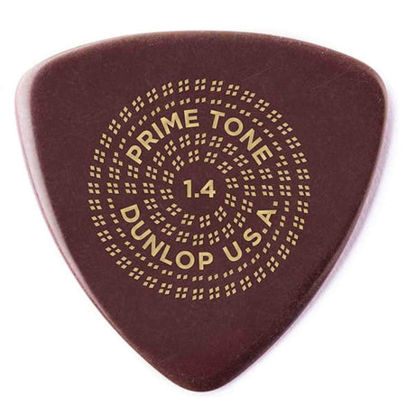 The image shows a Dunlop Primetone guitar pick in dark reddish-brown with gold lettering arranged in a circular pattern reading "PRIME TONE," "1.4," and "DUNLOP U.S.A." This 1.4mm thick pick is part of Dunlop’s premium Primetone series, known for sculpted edges and hand-finished tips, offering excellent tone, control, and playability favored by professional and serious guitarists.